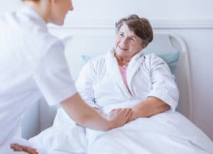 Nursing Assistant caring for an elderly patient